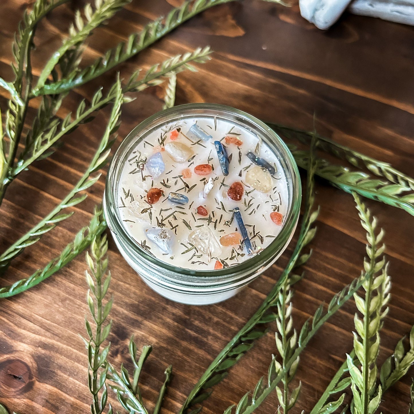 White intention crystal candle with kyanite crystal, citrine crystal and herbs for manifesting protection and cleansing energy.