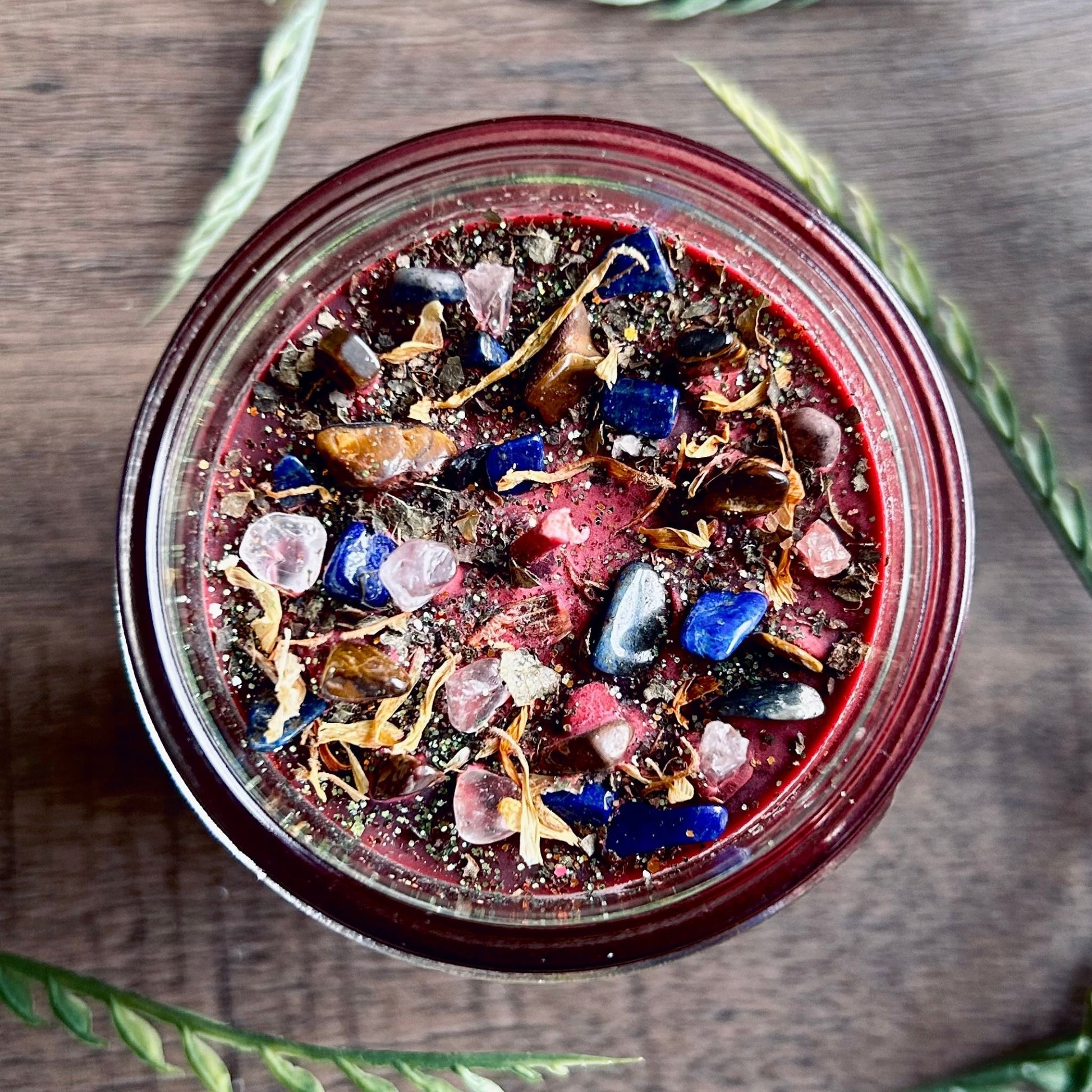Pagan Intention candle that is decorated with witchy crystals, flowers, and magic glitter to represent Mabon.