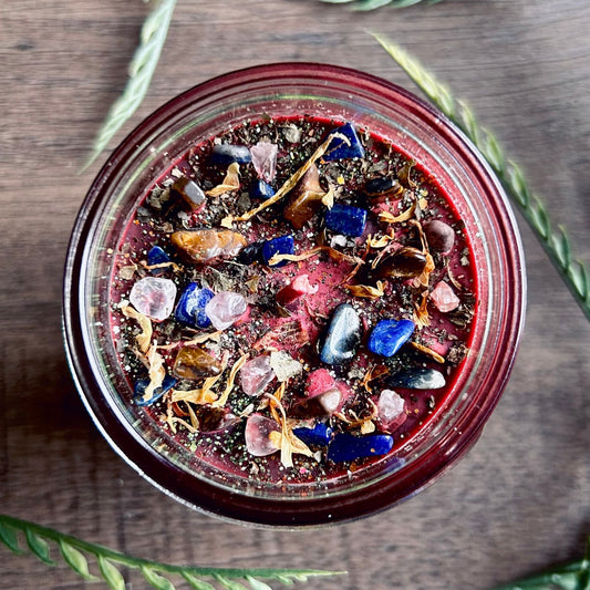 Pagan Intention candle that is decorated with witchy crystals, flowers, and magic glitter to represent Mabon.