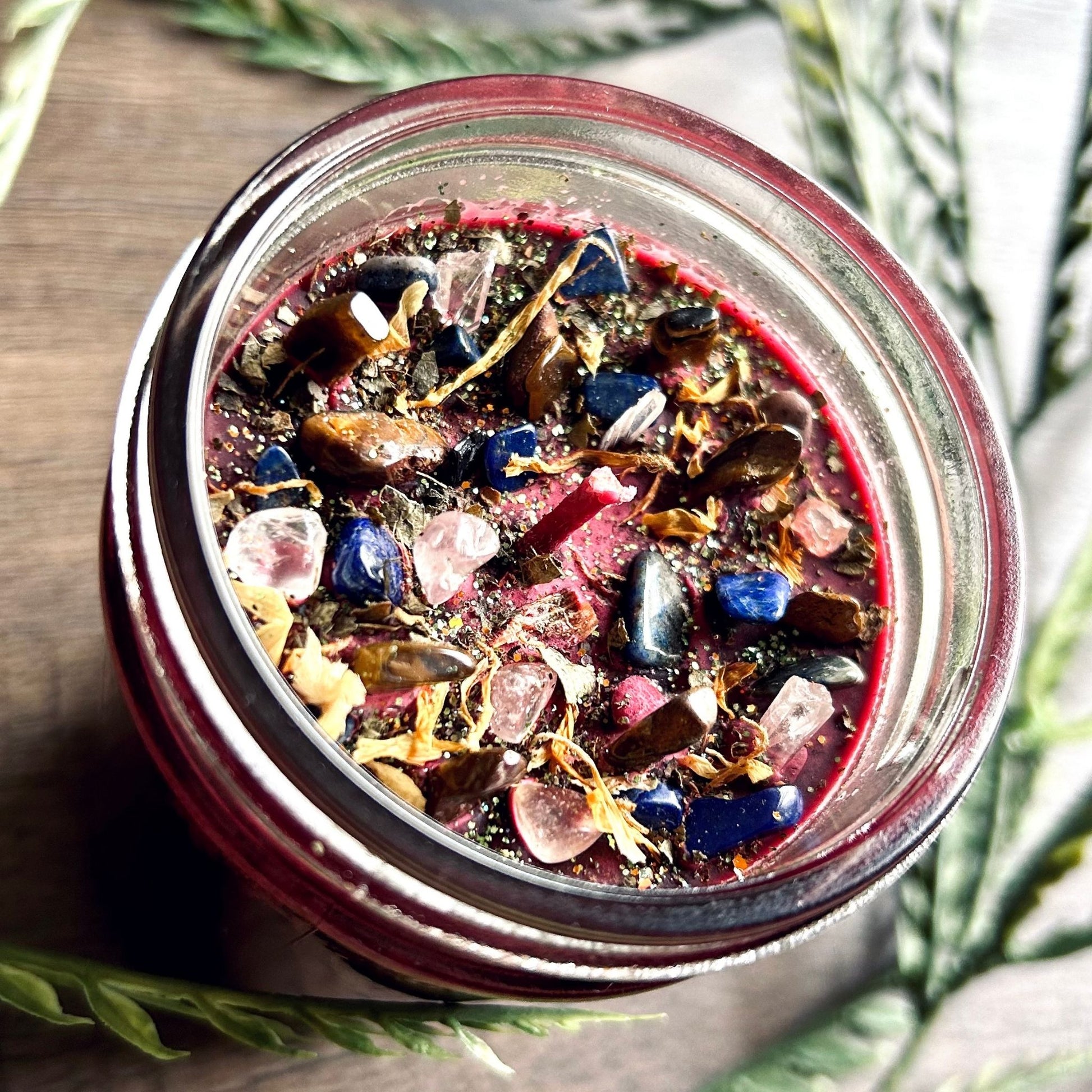 Pagan Intention candle that is decorated with witchy crystals, flowers, and magic glitter to represent Mabon.