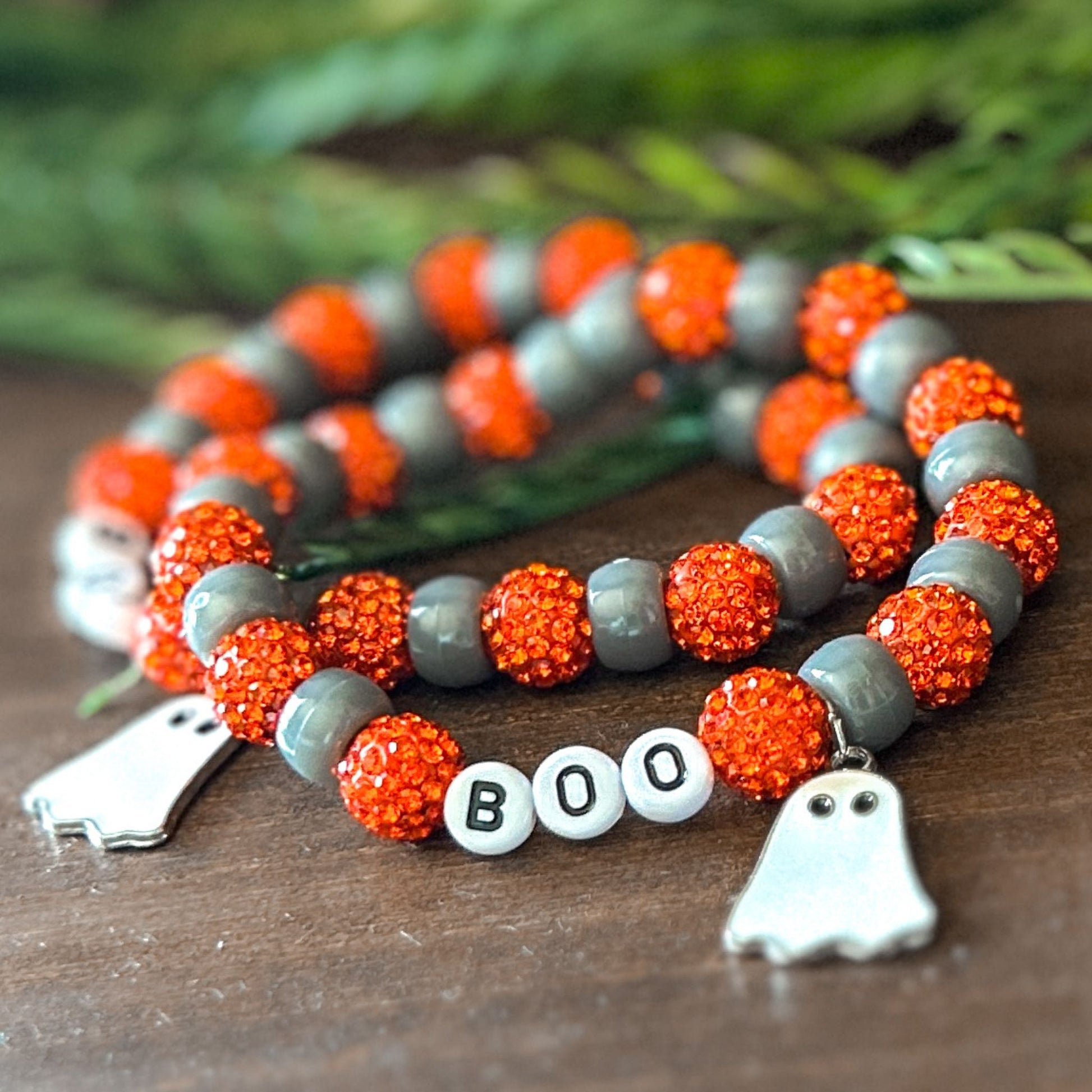 Halloween Bracelet with sparkly orange and gray beads with letters that say Boo. The bracelet also has a ghost charm.