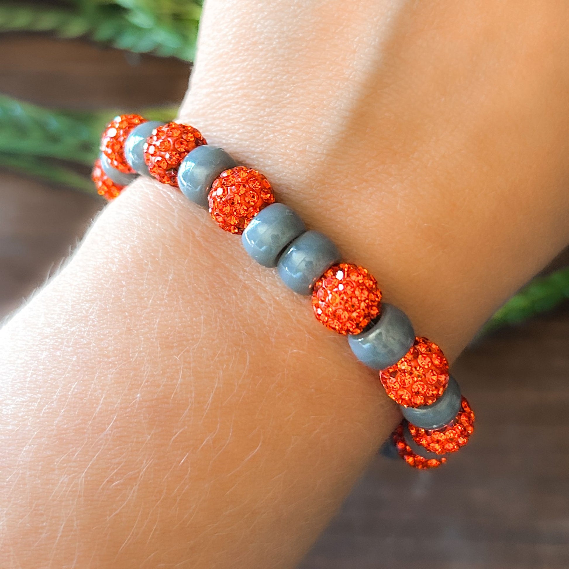 Halloween Bracelet with sparkly orange and gray beads with letters that say Boo. The bracelet also has a ghost charm.