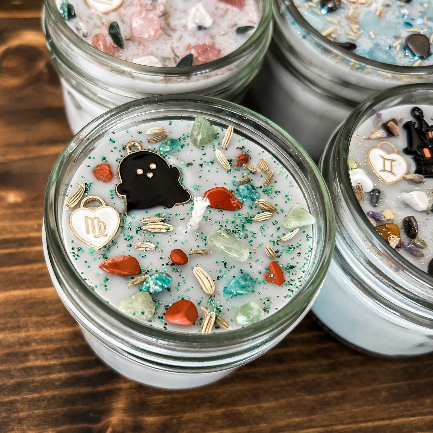 Spooky Virgo Zodiac Candles with crystals, herbs, glitter, and a Halloween design.