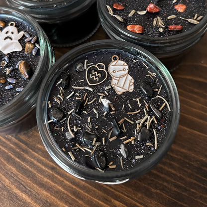 Spooky Aquarius Zodiac Candles with crystals, herbs, glitter, and a Halloween design.