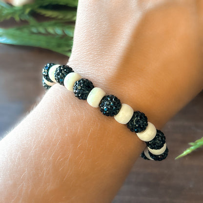 Halloween Bracelet with sparkly black and white beads with letters that say Spooky. The bracelet also has a ghost spider.