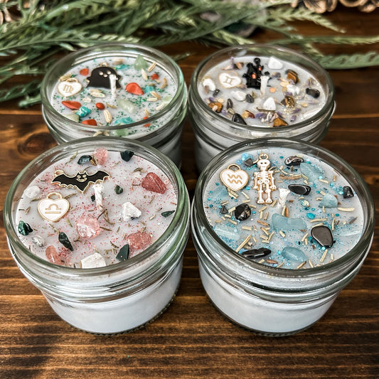 Spooky Zodiac Candles with crystals, herbs, glitter, and a Halloween design.