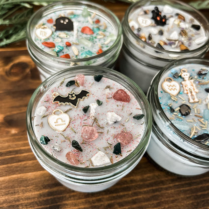 Spooky Libra Zodiac Candles with crystals, herbs, glitter, and a Halloween design.