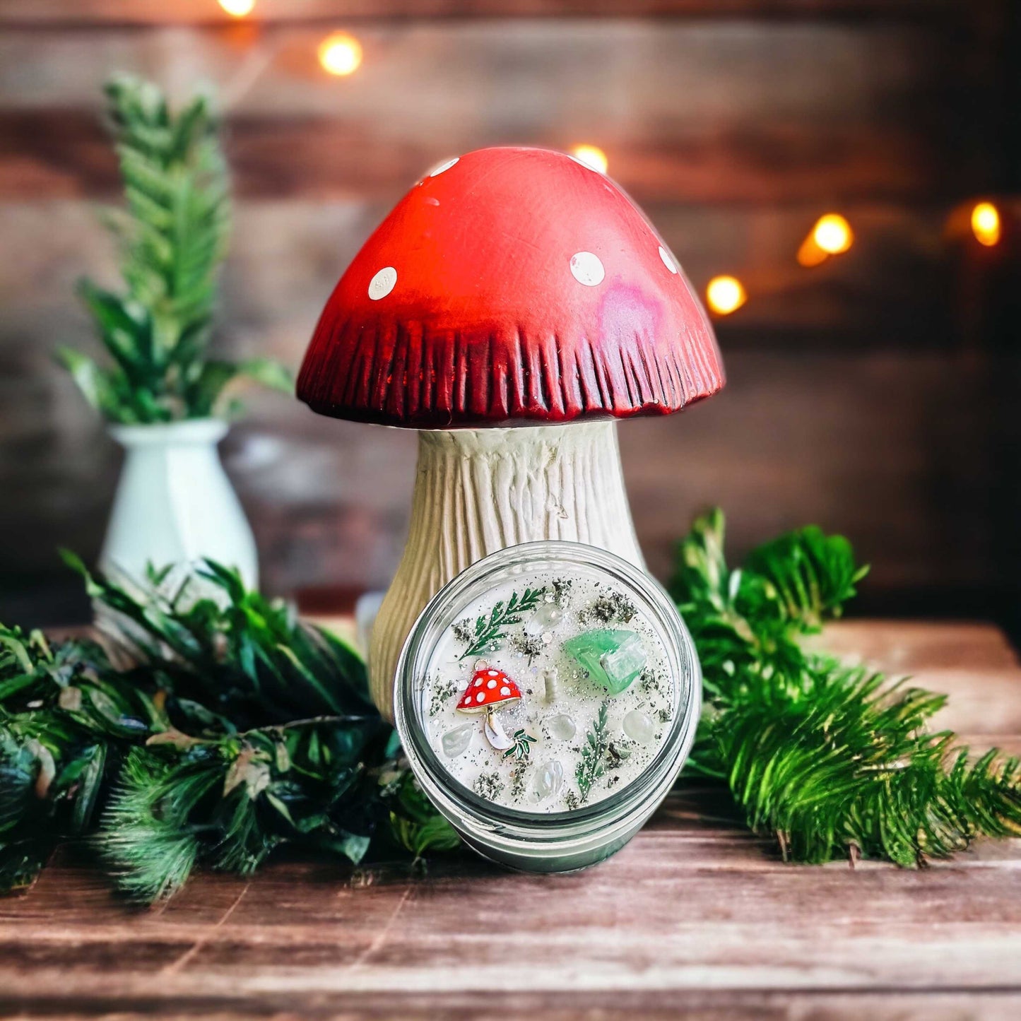 Mushroom candle that looks like a fairy realm with crystals, leaves, and glitter.